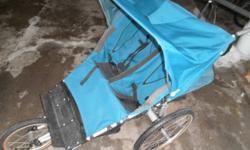 Kool-stride. Very easy to control with one hand while jogging. Wheels remove easily and entire unit collapses flat for easy transportation. Sun-visor, hand brake, peek-a-boo window, seats can recline for sleeping children, storage netting behind and