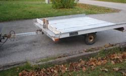 Tilting Snowmobile trailer for sale. Double wide Also works great for 2 ATV's. 8ft wide X 8ft long, with a good spare tire 
 
 - Fully galvanized frame and deck.
- 1"78 coupling 
- Hauls very nicely even without a load
 
Reason for selling: looking for a