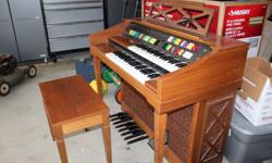 WALNUT 1981 ELECTRIC ORGAN COMES WITH MATCHING BENCH AND INSTRUCTIONS. WEST END LOCATION. CALL TANYA 780-966-4924.