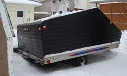 I am selling a double wide enclosed snowmobile trailer. It has a aluminum ramp that can be used at the front or back of the trailer. It has fat boy tires,traction mats,interior light, is lockable and frame is aluminum.