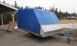 Enclosed Tilting Double Snowmobile Trailer. Professionally canvased, no rips or cuts, comes with spare, just licensed til next november.