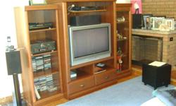 Entertainment Center consisting of 3 Units.   Purchased from Stoney Creek Furniture.  Colour is Amaretto
Each of the three units stands on its own. 
Center Unit has two drawers and two shelves below and an upper shelf.  There is a Power Bar mounted in the