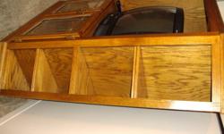 Solid oak Entertainment unit, holds 32in Tube T.V. Has book Shelf Type corners, great for picture frames or knick knacks. Bottom with glass doors. Still in Amazing shape, no damages, dents, knicks or scratches. Doesnt look worn at all. Just purchased a