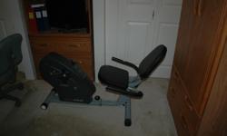 Exercise machine with chair like seat and bike pedals. Works fine but in the way and not being used.