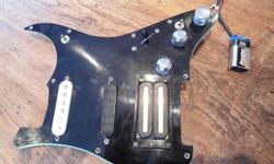 Pickguard (modified), tone pots, 5 way switch and wiring is from my 1979 american strat- this guitar pick up assembly was heavily modified sometime in the 80's, with a Schaller humbucker (think brown sound), a bartolini jazz in the mid, and strat single