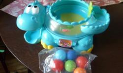 Fisher-Price - Go Baby Go - Poppity Pop Musical Dino
The Poppity Pop Dino is an adorable Dinosaur character and 6 brightly coloured balls. As baby bats at the roller ball, drops one of the balls down the dino's tail or onto his "back", the popping action