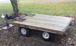 I have a flat bed trailer forsale.  It has double axles on it and i just put the wood on last year.    The trailer is 6' 2" long  and 4' 8" wide its in pretty good shape but it does have a flat tire and it needs a brake light...   its fits a four wheeler,