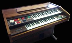 Double keyboard electronic organ with foot pedals.
As-is