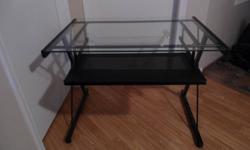 Glass desk in excellent condition. Just need to downsize. Measures 2 ft by 3 ft with an extra wide keyboard tray. Must pick up. $75 OBO.