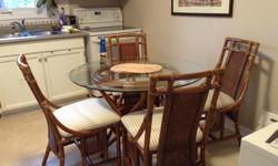 Beautiful rattan kitchen table set and 4 chairs. All pieces in excellent condition and is need of a new loving home. We would love to keep this set as it's still close to our heart, but a recent kitchen redesign no longer can accomodate it. Our loss is