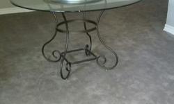 48" beveled glass topped dining/kitchen table on iron base , plus 4 padded upholstered chairs. Like new. Pick up only.