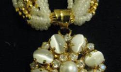 This is a beautiful antique style set comes complete with earings, necklace and ring. It has a stunning Indian design. It's pearl beads are accented with bits of gold tone for an eye-catching look. This costume jewelry is in perfect condition and has a