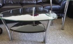 Beautiful/Stylish Glass coffee table with black shelves. Comes with two matching end tables perfect fit into the corners. Very stylish with Chrome legs and perfect height. We are selling due to safety for our little one, barely used.
All 3 pieces are in