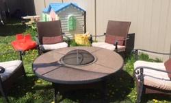 New PRICE: An awesome GRANITE table with fire bowl in the middle with cover and 4 arm chairs with cushions. Good condition and super high quality.