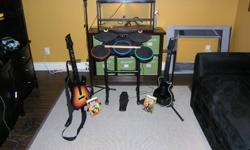 2 guitars with stands,1 drum set with pedal and sticks,1 microphone with stand and 2 games guitar hero world tour, guitar hero 3 legends of rock.