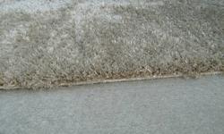 Hello,  I purchased an area rug on a whim for $700.00 and never used it once!
 
The rug is hand made in India (no child labour).
 
The rug is a neutral champagne colour (not grey like the pictures).
 
Size is 8' x 5' with a thick 1" pile.
 
The fibers are