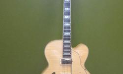 This is an Ibanez Artcore AF105 12 01. Beautiful mellow sound for those who like a jazzier feel to their playing. Flamed maple top, sides and back. Lovely detailing in hardwood for the tailpiece and tone/volume controls. There is a slight manufacturer's