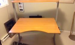 Excellent adjustable height computer/work desk in perfect condition. 4' x 3' adjustable height workspace and 4' x 14" adjustable top shelf. Very strong and stable.