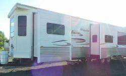 This beautiful cottage on wheels can comfortably sleep 7 and boasts 3 power slide outs,
18' power awning, 2 bedrooms, 2 bathrooms, 4 person dinette with storage
in the table and chairs. With many upper and lower cabinets and 3 closets,
you will not be