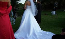 Beautiful Impressions Wedding Dress from 2006.  Size 4 draw string back so could go a size smaller or bigger, tailored for 5'7" with an inch heal.  Paid over $2000 brand new. Small red beads that were sewn in to match bridesmaids can be easily taken out.