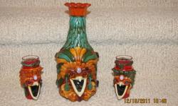 Indian Liquor Decanter
and 2 Shot Glasses with
Presious Stones.
Decanter = 9  1/2" high.
Shot Glasses = 4" high.
Made by grinding leather and mixing it
with acrylic glue, then forming and setting
presious stones.
A very atttractive set.
Price:    $90.00