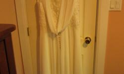 Lovely ivory wedding dress for sale. Only worn for 2 hours.
Size 13-14. Has a detachable cowl at the back. Comes with a garment bag.