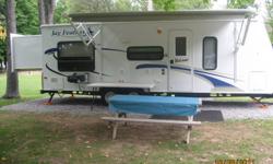 Just like new travel trailer!  Only used 10 times and stored inside garage otherwise.  Sleeps 7 comfortably.  Master bed slides out at the touch of a button, to a total of 30 feet of living space.  Has loads of extras including: an outdoor BBQ, outdoor