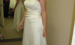 Joli Bridal wedding dress. Size 10 A-line Assemetical wedding dress is  preserved in a box since 2006.  .  Have a look at the pictures attached dress and shawl still in the box   Will deliver to Hamilton area if interested to buy. 
E-mail for any other