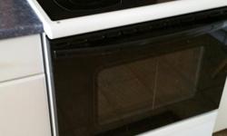 White smooth-top 30 inch range with self-cleaning oven. 4 burners,2 expanding. Also a warmer burner. Excellent condition