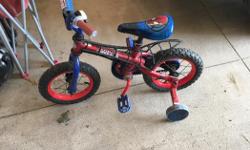 Spider man themed bike with training wheels. Great condition. Thomas the train themed helmet included