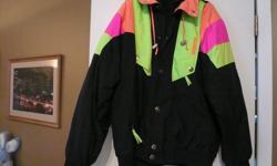 Black winter coat with neon. Is a SnowMass winter coat with Celtech features. Celtech features means, highly waterproof, air permeability, mouisture/vapour permeability, soft to touch & light weight. Keeps out mouisture and wind, yet hunidity from the