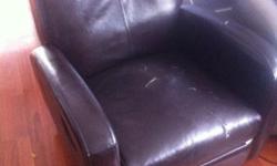 Small brown recliner. Some cracks in seat, but includes a patch/repair kit.