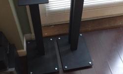 Older Lovan speaker stands (Decal on bottom says "Made for Lovan"). No spikes, but I have successfully been using nuts and bolts to raise off the floor. Both pillars are mass loaded.