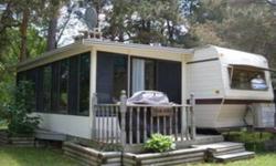 35ft Golden Falcon-  Reduced because it must go asap. Located near Madoc on a large corner lot. Sleeps 9 . Included is a deck, a shed and a 10' x 21'  Sunspace Florida room. This room is carpeted with glass, sliding screened windows all around. Furnace