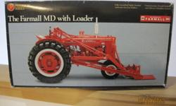 1947 McCormick Farmall MD with Loader - Ertl Precision Series 1/16 scale highly detailed authentic die-cast replica. The box is a little bit rough, but the tractor is in excellent condition. Also comes with a collector's medallion. This would be a great