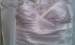 Hello All,
I am selling my Wedding dress which was never worn. It is a size 22, but it has the corset back so it can be smaller or bigger if needed. It is pure white, with a side bunch (not a big one). There is beading and embroidery on the top near the