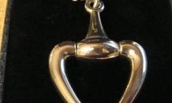 This authentic limited edition silver Gucci heart necklace was appraised at Knar Jewelers for $800. It is new and has a 24" chain. The pendant is a designer heart shape and is solid through and through. It has the words Gucci Italy very subtly engraved on