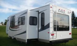 NEW 2011 298RLS EAGLE SUPER LITE - 2 YEAR FACTORY WARRANTY. BUY NOW - NO PAYMENTS TILL SPRING.  Lists for $32,800.00.  Elegant living for two with all the amenities of home.  Queen walk around bed with quilted bedspread, 2 swivel rocking chairs,hide-a-bed