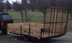 I have here a new built utility trailer.One inch hemlock lumber all new lights,spare tire,11 feet longbuy7feet wide.Tale gate is 7feet wide buy 5feet long,trailer has electric brakes that work all new.No suspension so you can haul more weight.nice trailer