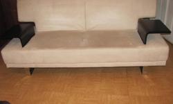 This couch also folds down into a double bed! it is in amazing condition because it was never used, we bought a leather couch instead, it is a cream color and is stored inside in a heated storage house, it has wooden arms and makes a great addition to a