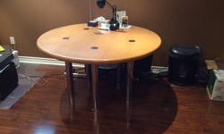Moving sale. This beautiful sturdy table can be modified to suit a dining table or coffee table. The oak top is some 3" inches thick and the legs are heavy gauge chromed steel. It is in mint shape. Dimensions are as follows: 54" x 30" tall.