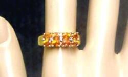 Solid new yellow gold natural sapphire ring.  10k setting that holds the natural orange sapphires is 18mm wide and ring is size 7.  Set closely together with a sturdy band.
Clearance items at lowest.
Please see my other items for sale.  All my items