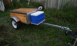Aluminium and wood box style trailer for use behind a motorcycle or small car, home built, all aluminium was profesionaly welded, has been pulled behind my motorcycle for several trips, it has been replaced by a camper. It has 12in tires, LED lighting,