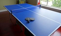 Blue ping pong table with rackets and balls. The ping pong table has been barely used and looks like new. The rackets were purchased last year and have been used only once or twice. As well with the ping pong table we have multiple ping pong balls.