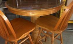 Solid Oak pub table and 2 chairs
pedestal
42" high
36" across
with protective glass for table top