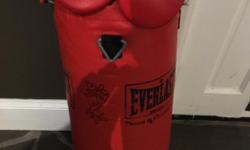 Smaller punching bag. Sorry I'm not sure how much is weighs but I'm guessing 50 lbs and its 31 inches tall. The gloves are size medium..