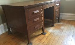 1950's - 1960's (??) era red oak office desk with slide-out typewriter table. Could use veneer repair and refinishing but is structurally sound. You pick up in Arnprior; this is a very heavy desk but does disassemble to a degree. I cannot help you load