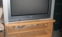 32" LG Flatron TV with custom built stand.TV is a 32" flat screen about 7 years old.(Large TV). I Don't think it is HD Stand was custom built to hold this TV. Made with oak veneer plywood and solid oak trim and drawer fronts. The 2 drawers have full