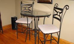 Rod Iron Bistro Set with glass top and two chairs.  Asking 125.00