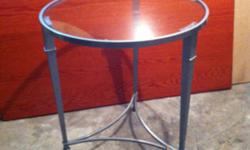 Two brand new, unused, round, glass top side tables with metal base in a brushed nickle finish.
Size is 22" diameter, 24"high
Original retail price for these two tables was $360.-